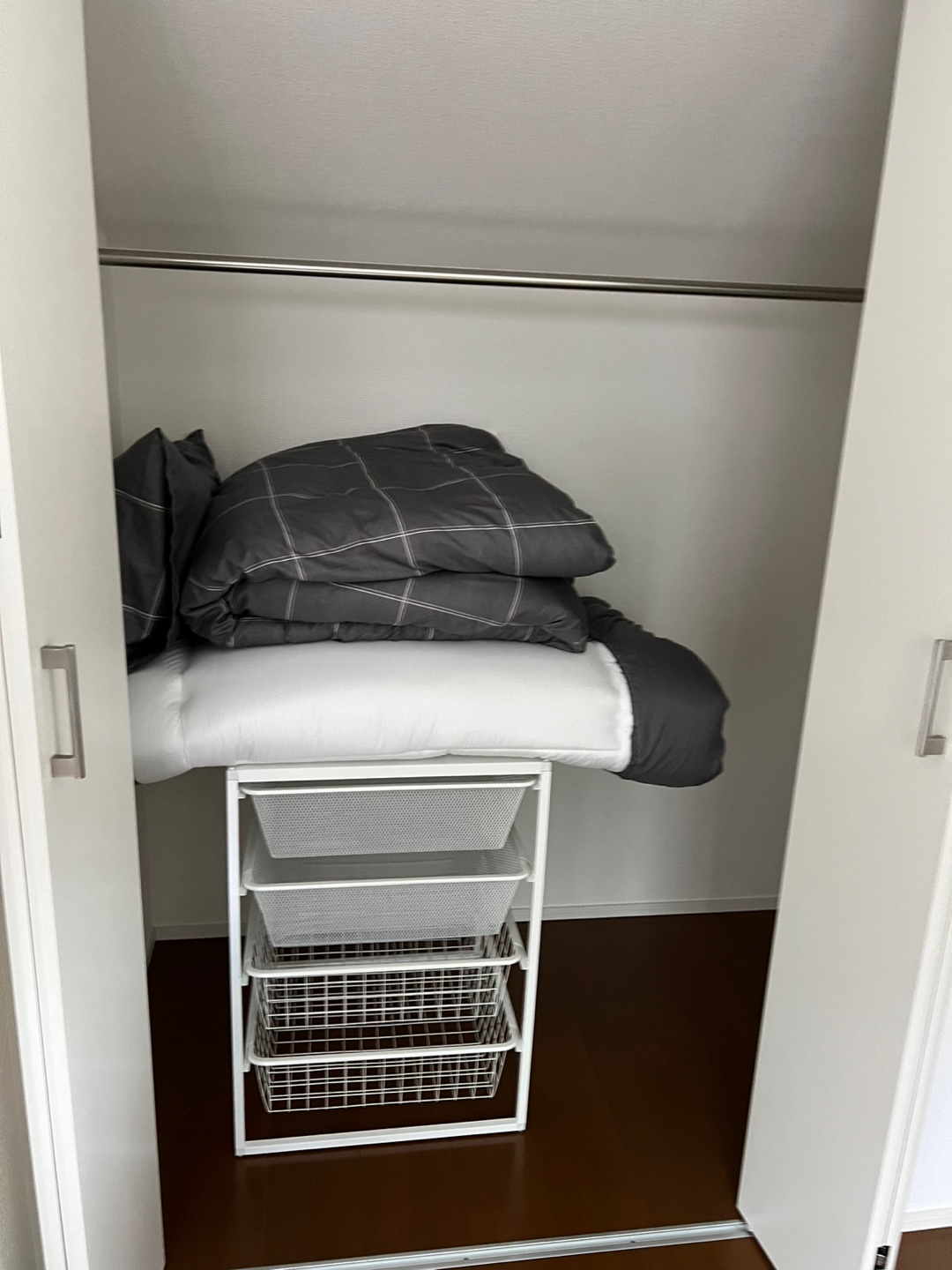Closet with hanging rail and storage baskets